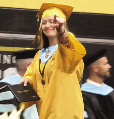A 2024 Excelsior Springs High School graduate points to her family after walking across the stage to receive her diploma. See pages 6 and 7 for story and additional photos. MIRANDA JAMISON | Staff