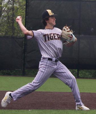 LANDON MARCUM throws to first, securing an out.