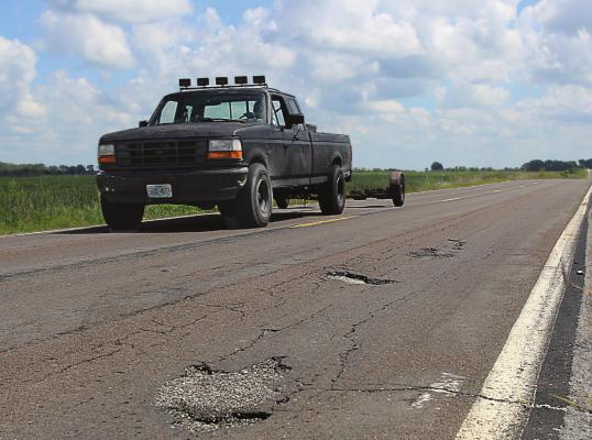 THIS DAMAGE is visible on Route J in southern Ray County. The surface, like surfaces on roads across the Northland, suffers from numerous cracks and potholes, with some of the wear being due to blowups, Missouri Department of Transportation information states. J.C. VENTIMIGLIA | Staff