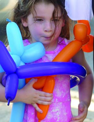 WYNNIE BASIL clings to her balloons as she learns how to make her own balloon costume. See story on page 6. ELIZABETH BARNT | Staff
