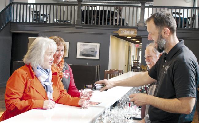 TONYA WATSON AND KELLI GOODING sample wine and chocolate mousse at Pairings by Van Till. Owner Cliff Van Till and General Manager Jason Van Till explain how pairing wine with the mousse brings out the undertones of the chocolate. KAYLA BREWER-CLEMENTS | Staff