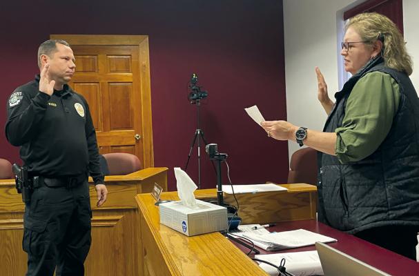 CAPTAIN ROBERT WARNER is sworn in for housing authority board by city clerk Shannon Stroud. MIRANDA JAMISON | Staff