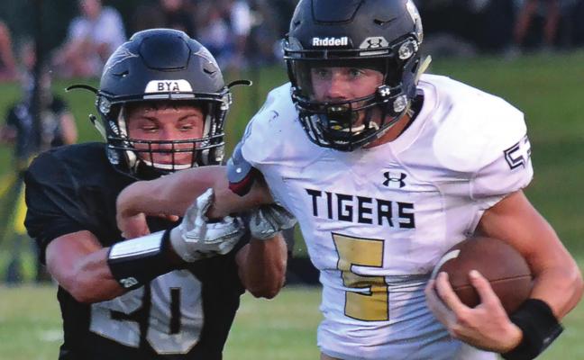 DESPITE INTENSE pursuit by Savannah defensive back Heisman Lafave, Tigers running back Lukas Shelton runs hard down the sideline during Excelsior Springs’ 33-21 Aug. 28 season-opening road win. DUSTIN DANNER | Staff