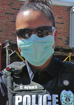 FIRST RESPONDERS RECEIVE FAULTY MASKS RICHMOND Police Officer Chassity Nevels wears a facemask to give out commodities. Masks are expected to help keep wearers from transmitting or being infected by COVID-19, but the state sent emergency management agencies faulty masks. J.C. VENTIMIGLIA | Staff