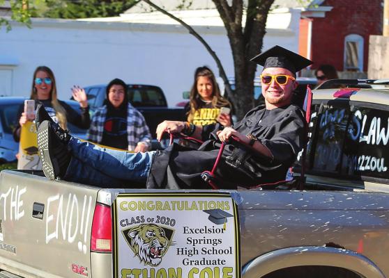 Alt Text for ImageDURING THE CLASS of 2020 Excelsior Springs High School Parade around the city May 8, Ethan Cole rocks the world from the back of a pickup truck.