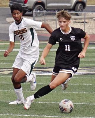 BRADY SCHOONOVER (right) races past a defender Sept. 12 at Tiger Stadium during Excelsior Springs’ 2-1 tournament victory over Maryville. DUSTIN DANNER | Staff