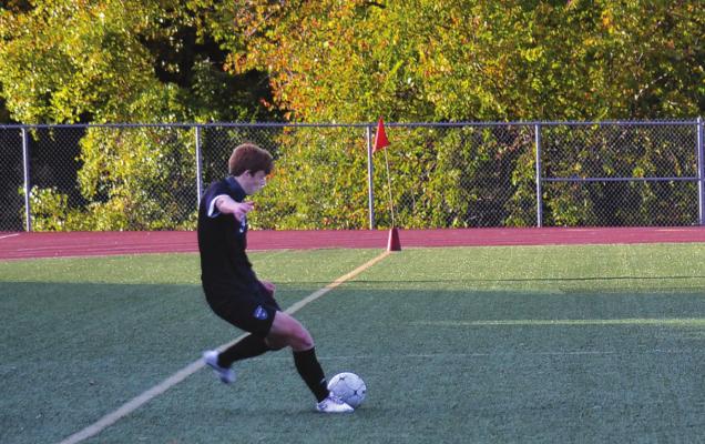 ETHAN EDWARDS executes a free kick for the Tigers against Smithville. DUSTIN DANNER | Staff