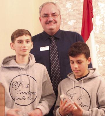 CHAMBER DIRECTOR Brian Rice (back) announces Camden Johnson (left) and Zander Wilkins as the Young Entrepreneurs of the Year. MIRANDA JAMISON | Staff
