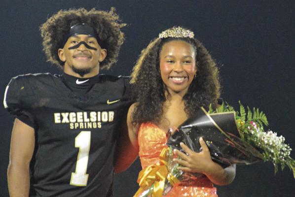 NICK MUBANGA (left) pulls double duty during Excelsior Springs’ homecoming game with Chillicothe, escorting his sister Audra during halftime. Audra was named freshman princess, while Mubanga scored two second-half touchdowns. Look for additional game coverage. SHAWN RONEY | Staff