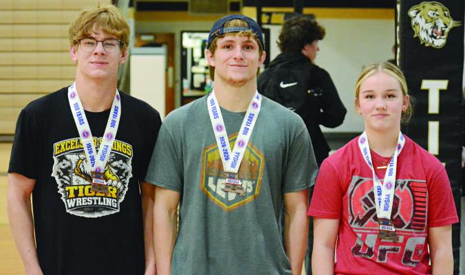 CARSON VANDOREMALEN (from left), Gage Carr and Lilly Goetz display their medals from state wrestling. SHAWN RONEY | Staff