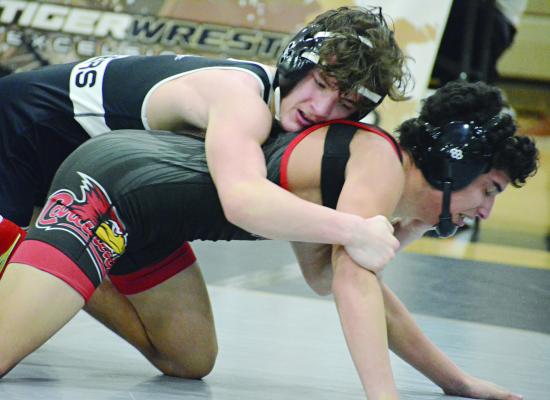 LOGAN BATES of Excelsior Springs (top) works to break down Christian Mora Perez during their third-place match at the Class 2 District 4 Tournament. SHAWN RONEY | Staff