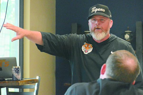 EXCELSIOR SPRINGS varsity football coach Jake Danneman extends his hand as he lectures during a coaching clinic for the Excelsior Springs Football Association. SHAWN RONEY | Staff