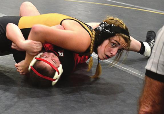 EXCELSIOR SPRINGS first-year high schooler Rylee Smith picks up a pin Dec. 9 during the Tigers’ home girls wrestling tournament. DUSTIN DANNER | Staff