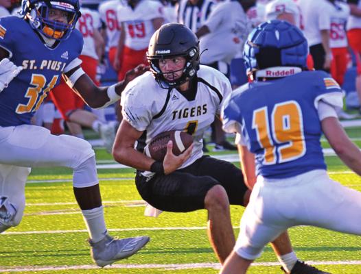JUNIOR QUARTERBACK Chance Moreland looks for running room during Excelsior Springs’ Aug. 20 preseason jamboree at St. Pius X of Kansas City. DUSTIN DANNER | Staff