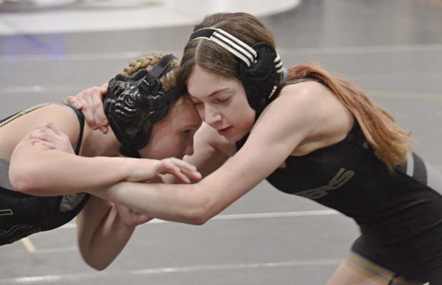 ISABELLA SCHOENECK of Excelsior Springs (right) ties up with Sierra Burris of Lee’s Summit on her way to winning the 14-and-under girls division title for 90-95 pounds at the Excelsior Springs Youth Tournament. DUSTIN DANNER | Staff