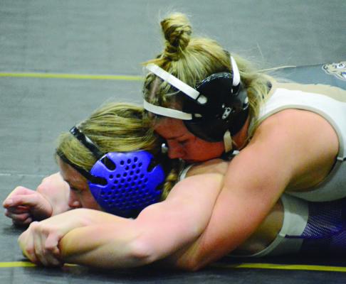 ANALESE HAPPY (right), an Excelsior Springs junior, works to break down Layla Palmer during the Lathrop Girls Turkey Break Tournament. SHAWN RONEY | Staff
