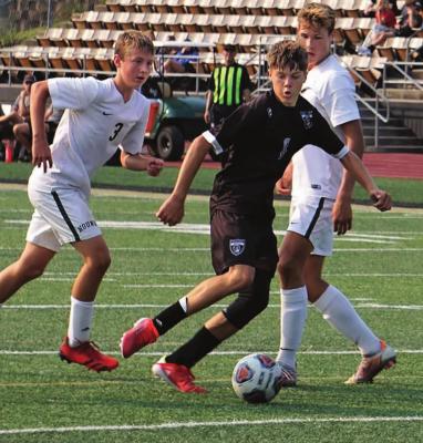 SOPHOMORE MASON WARTNER works his way through defenders during last week’s Excelsior Springs Tournament. Wartner has helped the Tigers bolt to a 5-2 start. DUSTIN DANNER | Staff