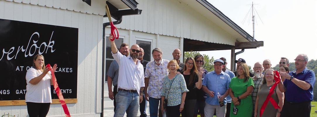 COMMUNITY MEMBERS and chamber representatives celebrate the opening of The Overlook, located at 14739 Crystal Drive in Crystal Lakes, with a ribbon-cutting event. The new venue offers indoor and outdoor space for weddings, gatherings and other events. MIRANDA JAMISON | Staff