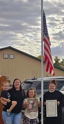 THE FAMILY OF fallen deputy Jeff Perkins is on hand to witness the flag being lowered to halfmast in his honor. Submitted