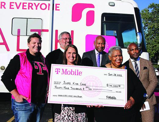FROM LEFT: MELISSA FLEMING, Dr. Jaret Tomlinson, Dr. Katherine Andreasen, Steven Lewis, Sandra Reece-Tinsley and Jeron Ravin are celebrating their funding by holding a check for $44,000 from T-Mobile to kick-start the ECC new childhood clinic project within the ECC building. SOPHIA BALES | Staff