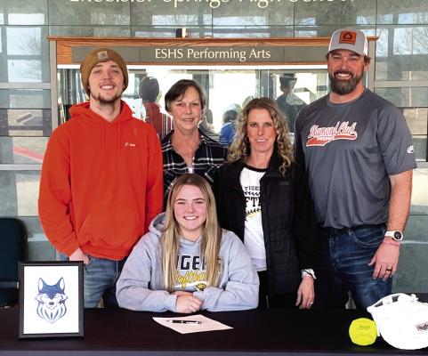 EXCELSIOR SPRINGS senior Daelyn Williams signs her letter of intent to play softball at Metropolitan Community College-Maple Woods in Kansas City with members of her family behind her. Pictured are, from left, brother Hunter Williams, grandmother Kenna Williams, mother Leigh Ann Williams and father Corey Williams. See story on page 7. DUSTIN DANNER | Staff