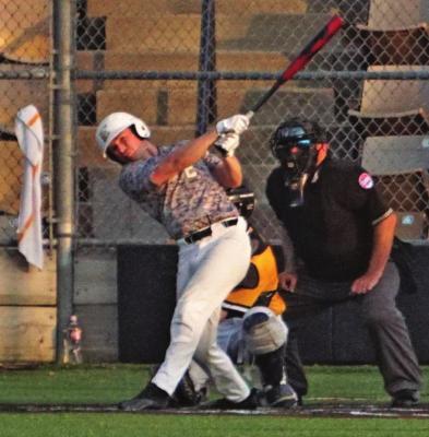 JUNIOR BROC DUSEK drives a single to left field last week during Excelsior Springs’ May 9 home doubleheader with Sedalia Smith-Cotton. Excelsior Springs splits the doubleheader, dropping the first game and winning the second. DUSTIN DANNER | Staff
