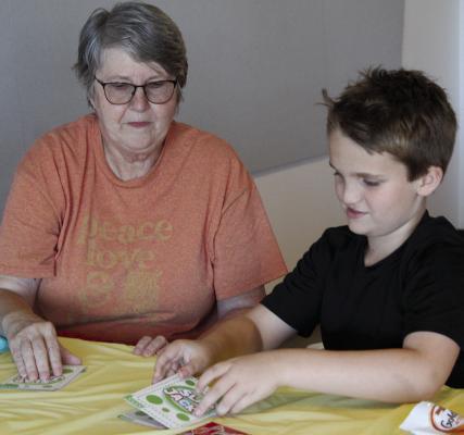 KATHY AND ELIJAH TWITCHELL play a game together during the Goodies with Grands event. MIRANDA JAMISON | Staff