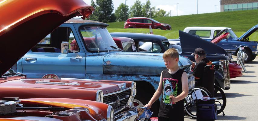TREY GROOMS admires the deep candy apple orange finish of a 1974 Chevrolet pickup during the car show fundraiser. MIRANDA JAMISON | Staff