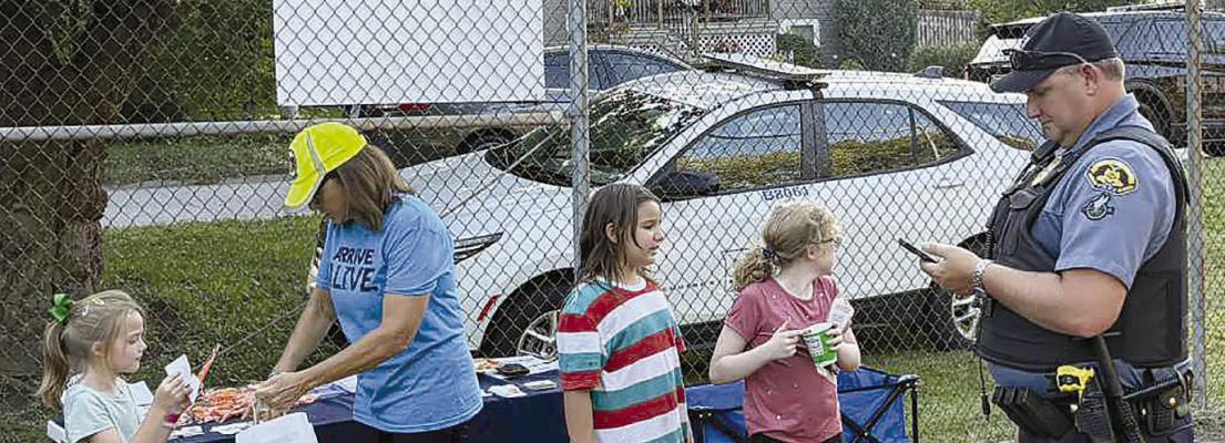 CLAYCOMO POLICE DEPARTMENT Sgt. Jared Sartin (right) builds positive police relationships with community youth. | Submitted