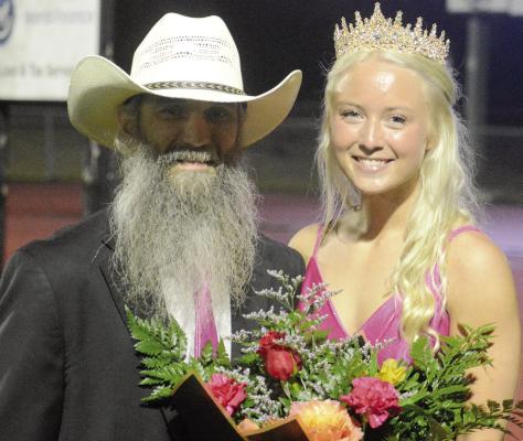 EXCELSIOR SPRINGS WRESTLING COACH Scott Schwab (left) is the father of royalty. Rikkie Schwab, his daughter, was crowned homecoming queen during halftime of Excelsior Springs’ varsity 11-man football game with Chillicothe. Look for game coverage in The Standard’s sports section. SHAWN RONEY | Staff