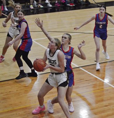 KINLEY ROGERS (center) draws a crowd as she looks to score against Lexington. DUSTIN DANNER | Staff