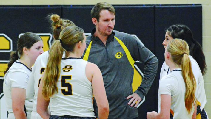 ORRICK VARSITY girls and boys coach Chris Harbison (center) talks to members of the girls team before facing Southwest of Livingston County/ Breckenridge. The Orrick girls won the Dec. 5 home opener 46-16. Orrick also defeated Southwest/Breckenridge in the varsity boys game 80-22. SHAWN RONEY | Staff