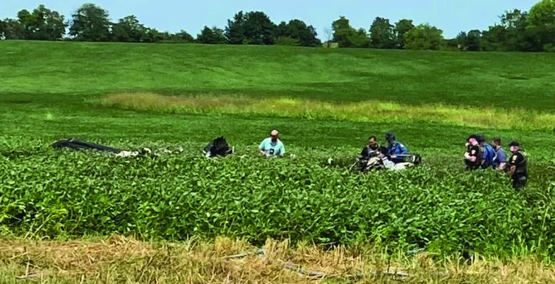 INVESTIGATORS EXAMINE wreckage from a fatal Cessna C340 crash near Mosby.