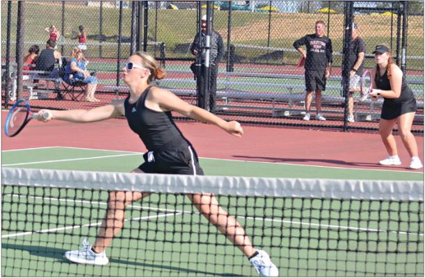 JUNIOR REBECCA McDADE reaches out to make a play near the net as her doubles partner, Olivia Deere, looks on from the baseline. DUSTIN DANNER | Staff