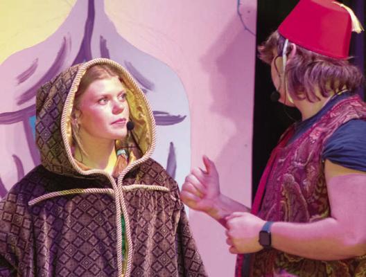 ADDISON CHAPMAN (left) and Rich Gear perform a character exchange.