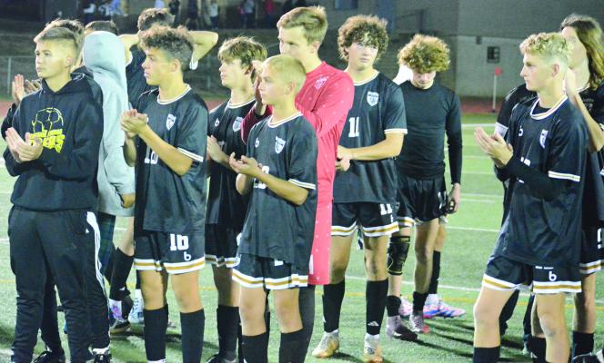 MEMBERS OF the Excelsior Springs varsity boys soccer program congratulate Maryville on winning the Class 2 District 8 title by applauding during the championship plaque presentation. SHAWN RONEY | Staff