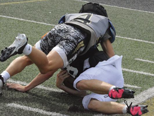 LUKAS VARDY (left) tackles Lathrop’s Drake Coots at the end of a run during a summer scrimmage. SHAWN RONEY | Staff