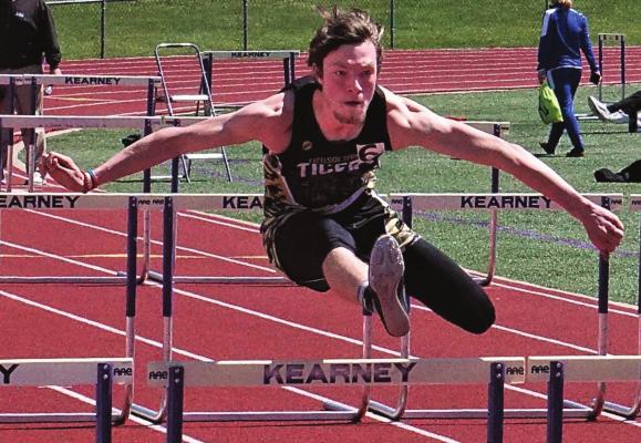 JUNIOR GAVIN WILLIAMS clears a hurdle en route to a second-place finish in the boys 300-meter intermediate hurdles April 8 at the Kearney Invitational. DUSTIN DANNER | Staff