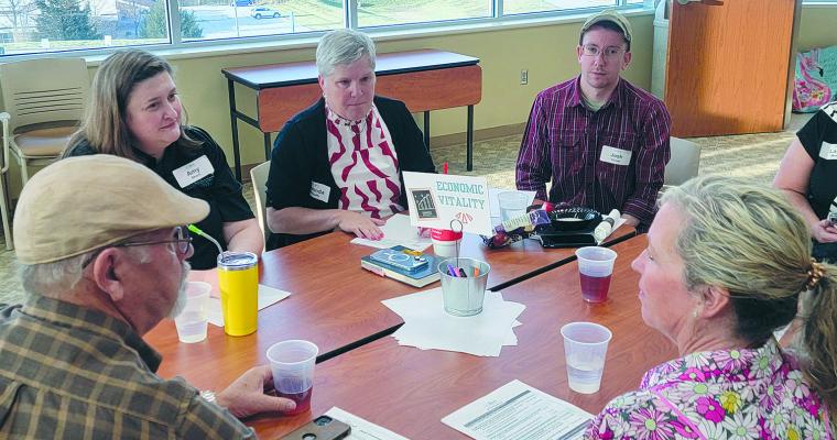 COMMUNITY MEMBERS engage in small-group discussions to provide input, which will guide future initiatives and planning efforts. Submitted