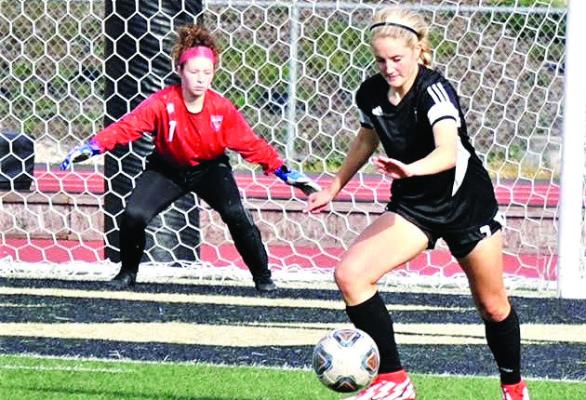 DEFENDER LAUREN MUELLER possesses the ball as goalkeeper Brooklyn Sharp watches. DUSTIN DANNER | Staff