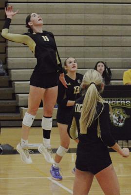 JORDIN PRICE (left) leaps to hit as her teammates watch during Excelsior Springs’ district volleyball meeting with Odessa. SHAWN RONEY | Staff