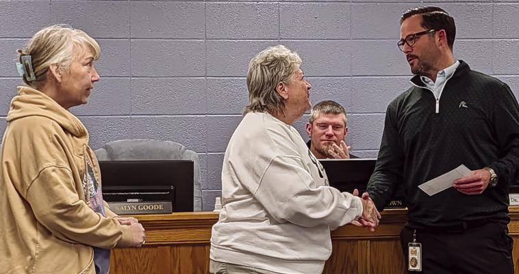 SUPERINTENDENT DR. MARK BULLIMORE (right) accepts a $500 donation from the Elks Lodge for delinquent lunch payments. Submitted