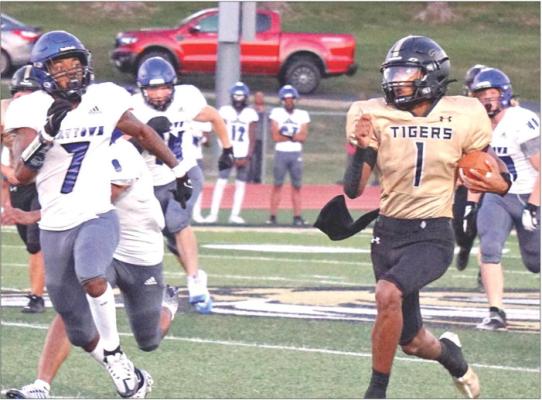 EXCELSIOR SPRINGS QUARTERBACK Marquez McCant (right) races down the sideline for a big gain against Raytown Aug. 31 at Tiger Stadium. TIM HARLAN | Staff