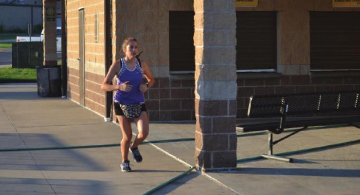 JACEY BREWER gets in a run on the Excelsior Springs High School campus. DUSTIN DANNER | Staff