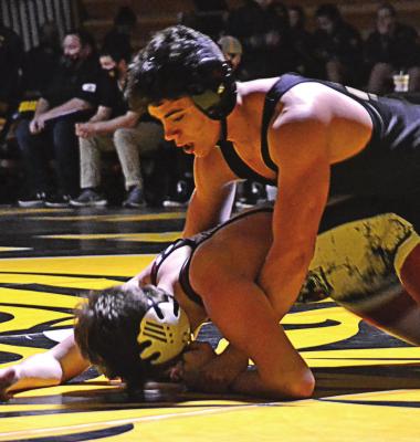 SENIOR CLINTON McCAULEY gets two points for a takedown and looks to maneuver his way to a win Dec. 9 at Cameron. DUSTIN DANNER | Staff