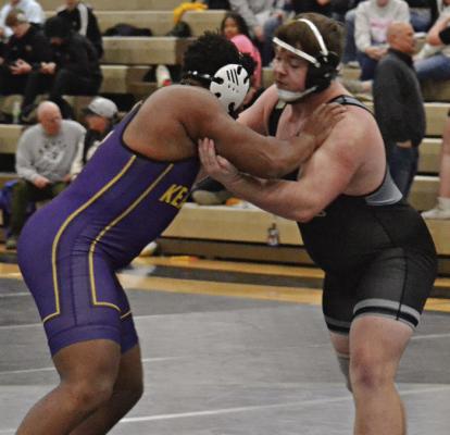 JUSTIN WRIGHT (right) ties up with Kearney’s Nykinson Belabre during a varsity boys wrestling dual. DUSTIN DANNER | Staff