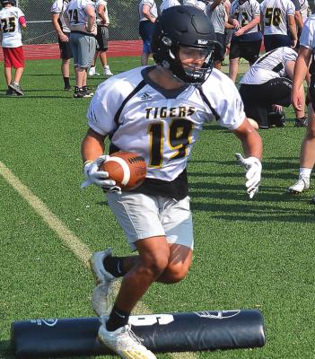 SENIOR DACEY HALL carries the football during drills at a preseason practice at Tiger Stadium. DUSTIN DANNER | Staff