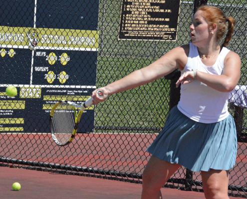 OLIVIA DEERE keeps her eyes on the ball while attempting a forehand shot during an Excelsior Springs tennis camp sessions for high schoolers. SHAWN RONEY | Staff