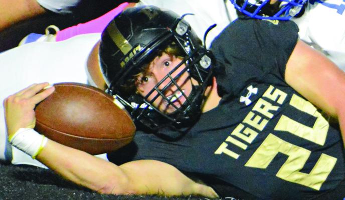 GAIGE CARR extends the ball into the end zone to cap his first-quarter scoring run during Excelsior Springs’ homecoming clash in 11-man varsity football with St. Joseph Central. SHAWN RONEY | Staff