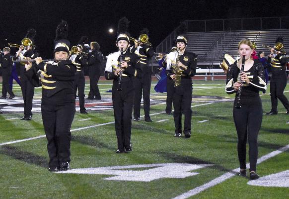 BAND MEMBERS ALINAH DODD, Sam Gillihan, Dylan Marrant, and Evelyn Selby pause to play during their show ‘Blue Print.’ The band ended the season with two first-place trophies for their field show. TARA ALTIS | Staff